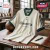 Off-white vintage-style soccer jersey with dark green trim, Chavarria lettering, and two trefoil logos on wood desk.!