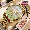 Winnie the Pooh 100th Anniversary gold tone quartz watch with an illustrated dial featuring Pooh Bear and Eeyore.