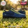 Custom navy blue suede sneaker with lime green accents, black sole, and Wings logo on green grass.!