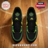 Nike Air sneakers in black, green, and yellow featuring Seattle Storm branding on the insole, displayed on a wood floor.!
