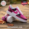 Breast cancer awareness sneakers in pink, white, and black with ribbon patterns on a wooden boardwalk.!