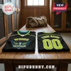 Two black Dallas Wings basketball jerseys with neon green trim, custom name, and number on a wooden locker room bench.!