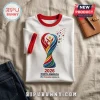 White ringer t-shirt with red trim featuring a colorful 2026 North America soccer trophy logo and small floating stars.!