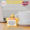 Yellow crocheted star plush with pink cheeks holding a card featuring an inspirational message on a desk near a mug.!