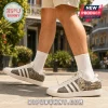 Adidas New Orleans Saints Who Dat Nation casual shoes featuring gold fleur-de-lis, mascot, and team graphics on white base.