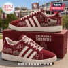Adidas Oklahoma Sooners Suede Casual Sneakers in crimson featuring white stripes and team graphics on a matching box.