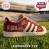 Adidas Oklahoma Sooners Suede Casual Sneakers in crimson with white stripes, featuring team graphics on a grass field.