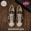 Adidas x Chucky Horror Movie Casual Sneakers featuring textured canvas, red heel tabs, and white shell toes on wood floor.