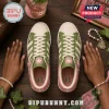 Alpha Kappa Alpha Floral Casual Sneakers in green and pink with pearl accents on a wooden background.