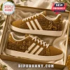 Alpha Phi Alpha Cornell University gold sneakers featuring Sphinx imagery, white stripes, and custom fraternity branding.