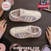 Ariana Grande x Adidas 7 Rings Lavender casual shoes featuring custom pastel graphics, cream laces, and branding on a table.