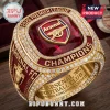 Arsenal FC 2026 Premier League Champions Ring with central red stone, gold band, and encrusted clear crystals.