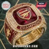 Arsenal FC 2026 Premier League Champions Ring with a red center stone, gold plating, and surrounding clear rhinestones.