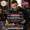 Baltimore Ravens Monopoly Collector Board Game box held by a man wearing a purple Ravens hoodie in a library setting.