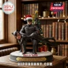 Batman and Catwoman Personalized Christmas Tree Ornament features Batman holding Catwoman on his lap by a festive tree.