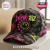 Blink-182 Neon Smiley Camo Cap featuring a black, grey, and neon pink camouflage pattern with a graphic smiley face logo.