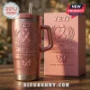 Breast Cancer Awareness 2026 YETI Stanley Tumbler in metallic pink featuring ribbon and butterfly graphics on a wood table.