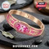 Breast Cancer Awareness Pink Crystal Bracelet in rose gold tone with a central pink gemstone and wing motifs on stone.