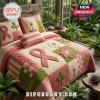 Breast Cancer Awareness Quilted 3-Piece Bedding Set with pink ribbons, floral patterns, and green accents in a greenhouse.