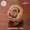 Brisbane Broncos 38th Anniversary Luxury Ring in gold with red, orange, and white accent stones on a wooden surface.