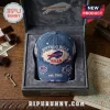 Buffalo Bills Est 1960 Patch Distressed Baseball Cap in a velvet-lined collector box on a wooden desk.