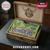 Canberra Raiders Distressed Green T-Shirt with Viking emblem and NRL logo inside a decorative wooden keepsake box.