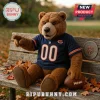 Chicago Bears Plush Teddy Bear Mascot Toy wearing a navy jersey with number 00, sitting on a wooden bench with a football.