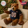 Chicago Bears Plush Teddy Bear Mascot Toy wearing a navy jersey with number 00, sitting on a beige couch near a tree.