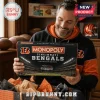 Cincinnati Bengals Monopoly Collector Board Game box held by a man wearing an orange and black hoodie in a wood-paneled room.