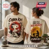 Cobra Kai Strike First Strike Hard cream t-shirt featuring Snoopy in a karate gi with red sun and Japanese calligraphy.
