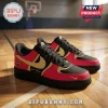 Custom WNBA All Teams Black Edition Nike Air Force 1 sneakers with red and gold panels sitting on a hardwood basketball court.