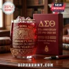 Delta Sigma Theta 112th Anniversary Drinking Glass with etched elephant design and gold rim filled with red liquid and ice.
