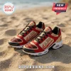 Delta Sigma Theta Crimson Gold Custom Name TN Sneakers with DST Greek letters, placed on sandy beach terrain.