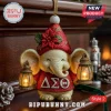 Delta Sigma Theta Elephant 2026 Christmas ornament wearing a red Santa hat, poinsettia, and holding two glowing lanterns.