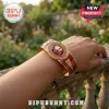 Delta Sigma Theta Elephant Hinge Bracelet featuring a red emblem with a gold elephant on a gold-toned metal cuff.