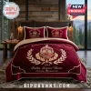 Delta Sigma Theta Maroon Quilted 3-Piece Bedding Set with gold embroidery, crest, and lettering on a bed in a cabin room.
