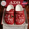 Delta Sigma Theta Red Crocs With Charms featuring Greek letters, 1913 branding, and decorative shoe pins in a gift box.
