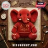 Delta Sigma Theta Red Elephant Plush Toy wearing a shirt with Greek letters sitting on an open vintage library book.