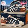 Denver Broncos NFL Casual Sneakers featuring blue suede, orange heel panels, team logos, and mountain skyline graphics.