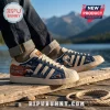 Denver Broncos NFL Casual Sneakers featuring navy and cream panels, mountain graphics, and United in Orange text.