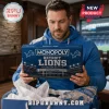 Detroit Lions Collector Monopoly Board Game box held by a man wearing a blue hoodie with Ford Field imagery.