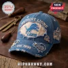 Detroit Lions Distressed Vintage Denim Baseball Cap with blue fabric, embroidered logo, and worn edges on a wooden surface.