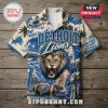Detroit Lions NFL Mascot Hawaiian Shirt featuring a roaring lion, football, helmet, and city skyline on cream fabric.