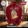 Dolly Parton In Loving Memory red hoodie with blonde hair portrait, white signature, and butterfly sleeve graphics.