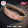 Dolly Parton Love Is Like A Butterfly bracelet featuring rose gold metal, pink enamel, crystal accents, and guitar motifs.