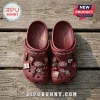 Dr Pepper Maroon Clogs with Charms featuring soda bottles, cherry icons, and logos on a weathered wooden background.