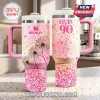 Elvis Presley 90th Birthday Pink Stanley Tumbler with dandelion floral print, sparkles, and a straw on a kitchen counter.