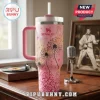 Elvis Presley 90th Birthday Pink Stanley Tumbler with dandelion floral print, white lid, and straw on wooden table.