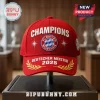 FC Bayern Munchen 2025 Champions red baseball cap with white embroidery, central club crest, and gold laurel branch detail.