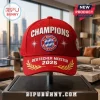 FC Bayern Munchen 2025 Champions red baseball cap with white embroidered text, central team logo, and gold laurel branch.